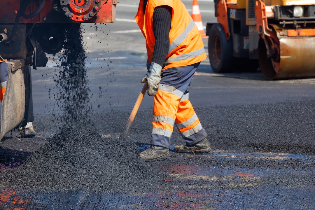 Asphalt paving crew working on commercial parking lot