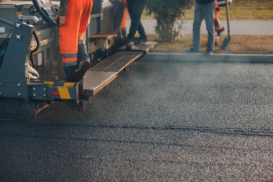 Industrial site paving with heavy equipment for commercial facility