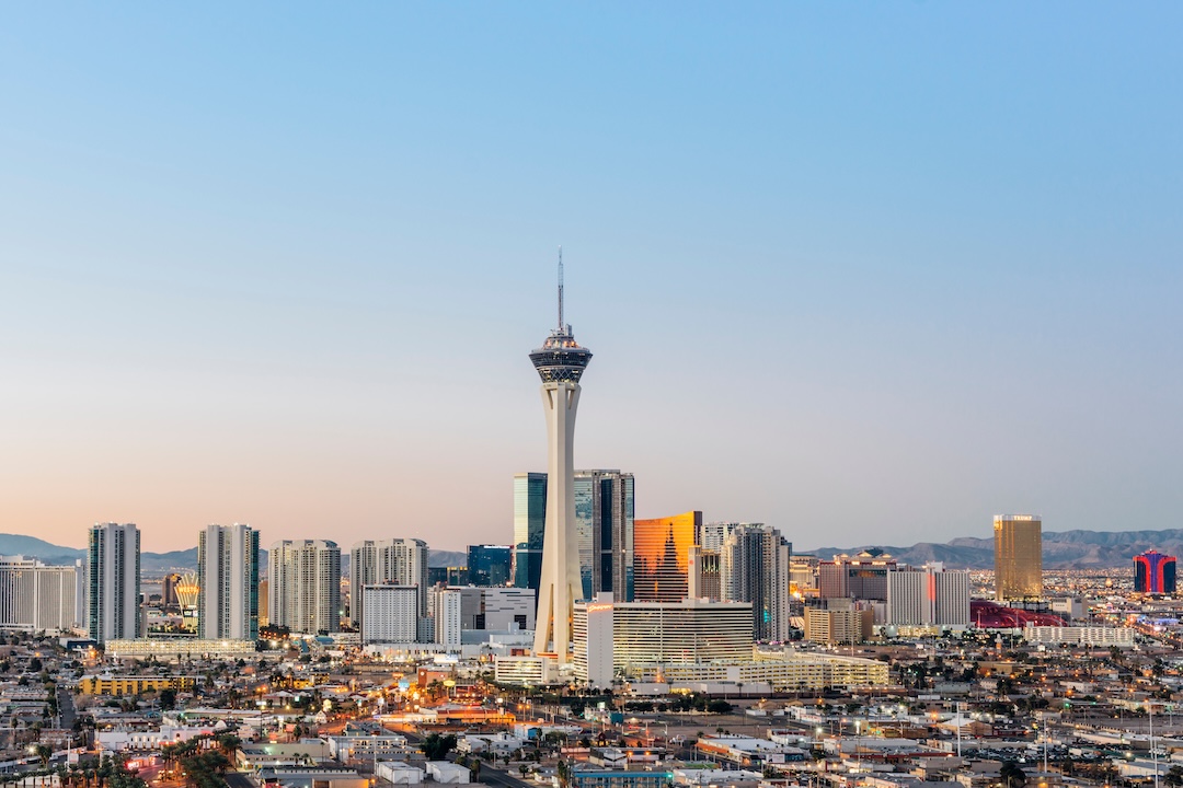 Las Vegas skyline with Stratosphere tower at dusk overlooking the city and surrounding desert mountains