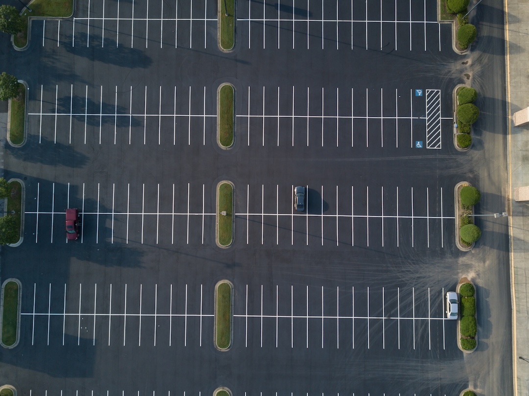 Aerial view of a freshly paved and striped commercial parking lot