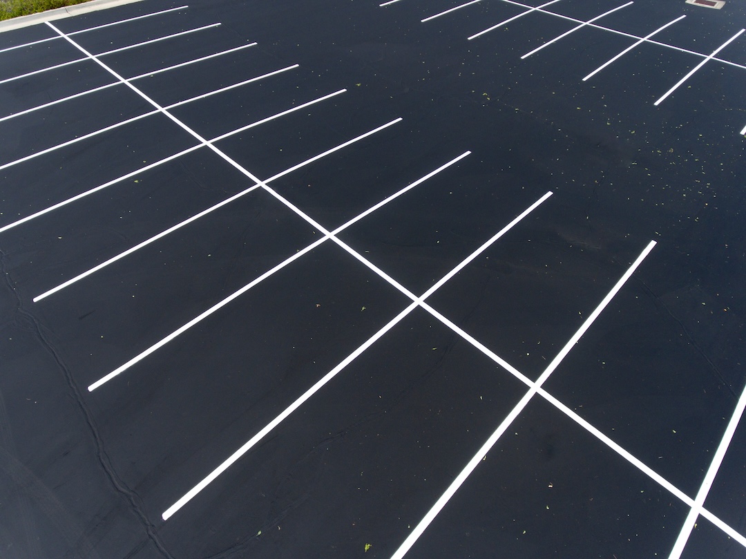 Aerial view of freshly striped HOA community parking lot